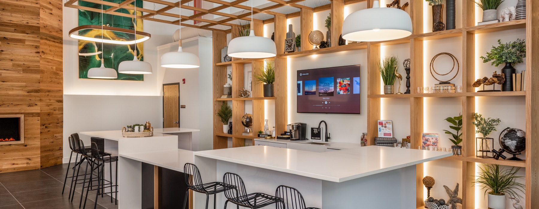 interior clubhouse featuring a large island and a accent-wall shelving display